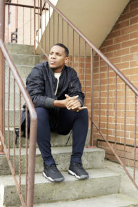 {icture of Reggie Yates sitting