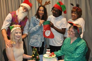 We Need a Little Christamas - Standing: Simon Nye, Nakita Allen, George Nzuba, Danalia Borman. Seated: Danielle Marx, Jean Marie Schoots. Pictures: Jane Amory